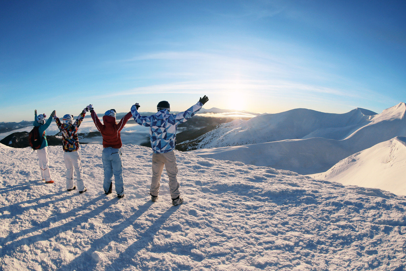 Group of friends celebrating at a snowy ski resort