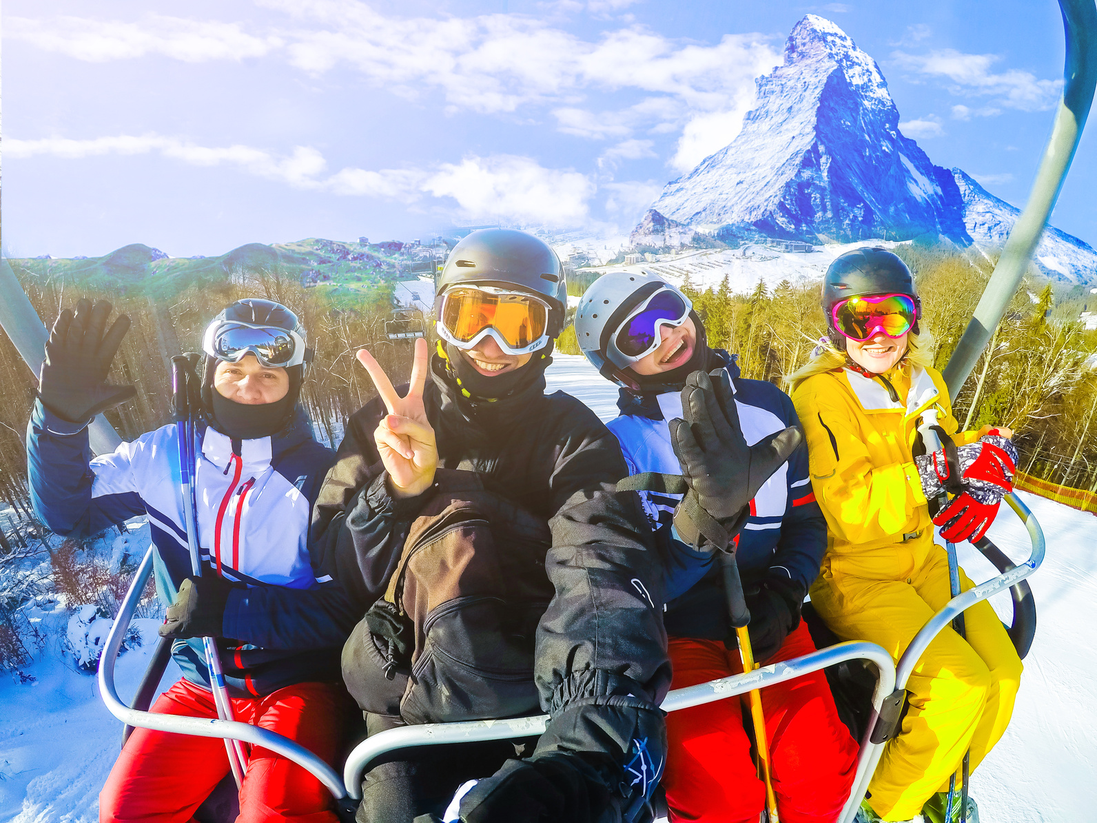 Group of friends on a ski chairlift with the Matterhorn behind them